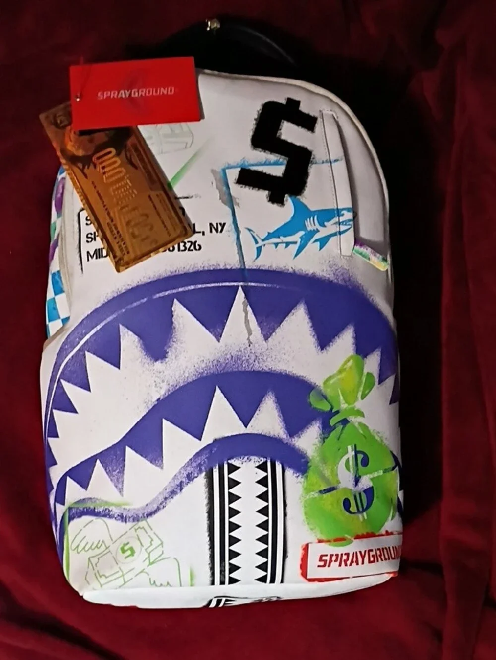 Sprayground White Backpack with Purple Shark Graphic and Green Money-Bag Accents
